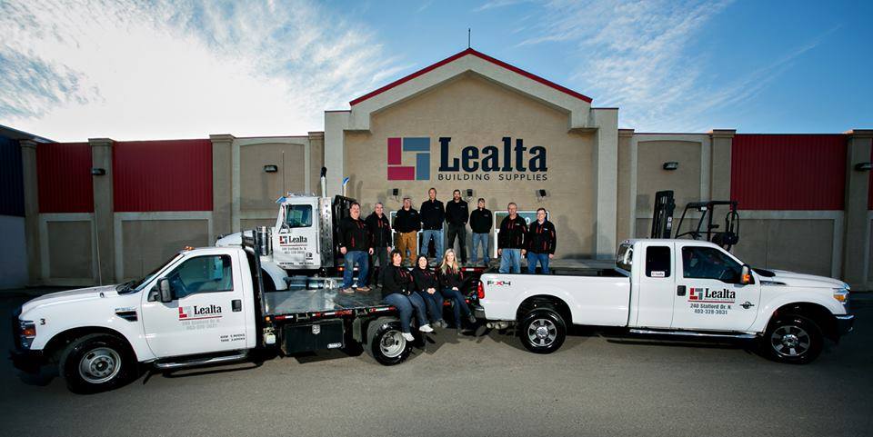 Lealta Building Supplies storefront with team and delivery trucks